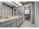 Bathroom features a double sink vanity, white tile flooring, and separate toilet area for privacy at 5282 Box Turtle Cir, Sarasota, FL 34232