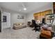 Cozy bedroom area with a sofa, desk, sewing machine and neutral decor with a ceiling fan at 5282 Box Turtle Cir, Sarasota, FL 34232