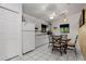 Traditional kitchen featuring tile flooring, modern appliances, and a cozy dining area at 5282 Box Turtle Cir, Sarasota, FL 34232