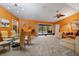 Open-concept living room with dining area features large windows and seamless access to the outdoor pool at 5282 Box Turtle Cir, Sarasota, FL 34232