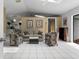 Bright and airy living room featuring tile floors, a comfortable sofa, and colorful accent chairs at 5282 Box Turtle Cir, Sarasota, FL 34232