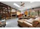 Spacious living room with stone fireplace, built-in shelves, wet bar and an access to the outdoor pool area at 5282 Box Turtle Cir, Sarasota, FL 34232