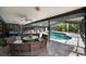 Inviting covered pool area with comfortable wicker furniture, perfect for outdoor entertaining and relaxation at 5282 Box Turtle Cir, Sarasota, FL 34232