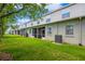 The backyard features a spacious lawn, screened patios, and neutral exterior colors at 5346 Neil Dr, St Petersburg, FL 33714