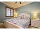 Bedroom with a colorful comforter, shuttered windows, and bedside lamps at 5346 Neil Dr, St Petersburg, FL 33714