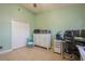 Bedroom featuring light green walls, tile floors, a ceiling fan, a workspace with a desk, and a closet at 5346 Neil Dr, St Petersburg, FL 33714
