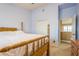 Bedroom with tile floors, light purple walls, a wooden bed, wood dresser and nightstand, and a closet at 5346 Neil Dr, St Petersburg, FL 33714