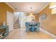Open-concept dining area with a view of the kitchen and staircase at 5346 Neil Dr, St Petersburg, FL 33714