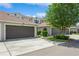 View of the townhouse featuring a brown garage door, well-maintained landscaping, and a charming exterior at 5346 Neil Dr, St Petersburg, FL 33714