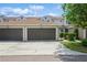 Townhouse featuring an attached garage, well-maintained landscaping, and a charming exterior at 5346 Neil Dr, St Petersburg, FL 33714