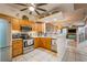 Open kitchen with stainless steel appliances, granite countertops, and a view into the living room at 5346 Neil Dr, St Petersburg, FL 33714