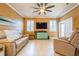 Cozy living room featuring tile floors, a ceiling fan, and natural light at 5346 Neil Dr, St Petersburg, FL 33714