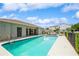 Community pool with ample seating, set against a blue sky and manicured landscaping at 5346 Neil Dr, St Petersburg, FL 33714