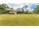 Well-maintained lawn with a screened-in pool and lanai, and lush landscaping at 5533 Ashley Pkwy, Sarasota, FL 34241