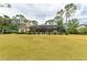 Large backyard with well-maintained lawn and a screened-in pool and lanai area at 5533 Ashley Pkwy, Sarasota, FL 34241
