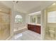 Bright bathroom featuring a bathtub, separate shower, and a vanity with ample counter space at 5533 Ashley Pkwy, Sarasota, FL 34241