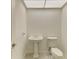 Powder room with pedestal sink, toilet, and tile flooring at 5533 Ashley Pkwy, Sarasota, FL 34241