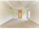 Carpeted bedroom with tray ceilings, white walls and neutral design scheme at 5533 Ashley Pkwy, Sarasota, FL 34241