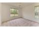 Bedroom featuring neutral carpeting and abundant natural light from large windows at 5533 Ashley Pkwy, Sarasota, FL 34241
