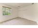 Carpeted bedroom with a ceiling fan, large window and double door closet at 5533 Ashley Pkwy, Sarasota, FL 34241