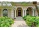 Close up of front entrance with double doors and manicured landscaping at 5533 Ashley Pkwy, Sarasota, FL 34241