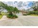 Charming home featuring a side view of the garage and a lush landscaped yard at 5533 Ashley Pkwy, Sarasota, FL 34241
