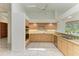 Kitchen boasts tile floors, light wooden cabinets, and updated stainless appliances at 5533 Ashley Pkwy, Sarasota, FL 34241