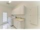 Laundry room with utility sink and ample cabinet space at 5533 Ashley Pkwy, Sarasota, FL 34241