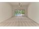 Light and airy living room with sliding doors to pool and patio at 5533 Ashley Pkwy, Sarasota, FL 34241