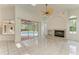 Bright living room with fireplace and sliding glass doors leading to the pool area at 5533 Ashley Pkwy, Sarasota, FL 34241