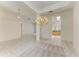 Open living space with tile floors, chandelier, and kitchen access at 5533 Ashley Pkwy, Sarasota, FL 34241