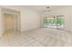 Neutral living room with access to patio area and tile flooring at 5533 Ashley Pkwy, Sarasota, FL 34241
