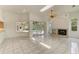 Living room with a fireplace and sliders to the pool area bringing natural light at 5533 Ashley Pkwy, Sarasota, FL 34241