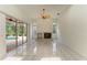 Cozy living room with a fireplace and sliding glass doors to the screened pool at 5533 Ashley Pkwy, Sarasota, FL 34241