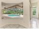 Lovely screened-in pool in a tropical backyard setting with brick pavers at 5533 Ashley Pkwy, Sarasota, FL 34241