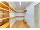 Walk-in closet with wooden shelves and a wooden floor at 5533 Ashley Pkwy, Sarasota, FL 34241