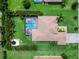 Aerial view of a landscaped property featuring a pool, spa, outdoor kitchen, and trampoline at 603 165Th E St, Bradenton, FL 34212