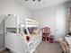 Bright bedroom features a white bunk bed, carpet, and a dollhouse at 603 165Th E St, Bradenton, FL 34212