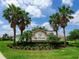 Community entrance sign amidst manicured landscaping and mature palms at 603 165Th E St, Bradenton, FL 34212
