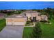 Beautiful single-story home featuring a three-car garage, manicured lawn, and a stone-accented facade at 603 165Th E St, Bradenton, FL 34212
