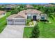 Beautiful single-story home featuring a three-car garage, manicured lawn, and a stone-accented facade at 603 165Th E St, Bradenton, FL 34212