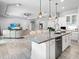 Open-concept kitchen with a large island, modern appliances, and breakfast bar seating at 603 165Th E St, Bradenton, FL 34212