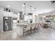 Open kitchen with stainless steel appliances, granite countertops, tile backsplash, and a cozy breakfast nook at 603 165Th E St, Bradenton, FL 34212