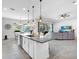 Open floor plan kitchen features island with seating, stainless appliances, and seamless flow to the living area at 603 165Th E St, Bradenton, FL 34212
