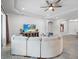 Comfortable living room with plank wall, TV, recessed lights, ceiling fan, tile floor, and an arched doorway at 603 165Th E St, Bradenton, FL 34212