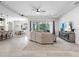 Inviting living room showcases neutral tones, tile floors, recessed lighting, and a sliding glass door to the lanai at 603 165Th E St, Bradenton, FL 34212