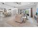 Bright living room features an open floor plan, modern ceiling fan, and sliding glass doors to the outdoor patio at 603 165Th E St, Bradenton, FL 34212