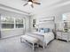 Airy primary bedroom with tray ceiling, carpet floors, and sun-filled windows at 603 165Th E St, Bradenton, FL 34212