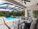 Enclosed patio with a seating area and views of the pool and garden at 603 165Th E St, Bradenton, FL 34212