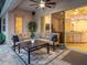 Comfortable covered patio featuring an outdoor ceiling fan, a plush sofa, and a coffee table at 603 165Th E St, Bradenton, FL 34212